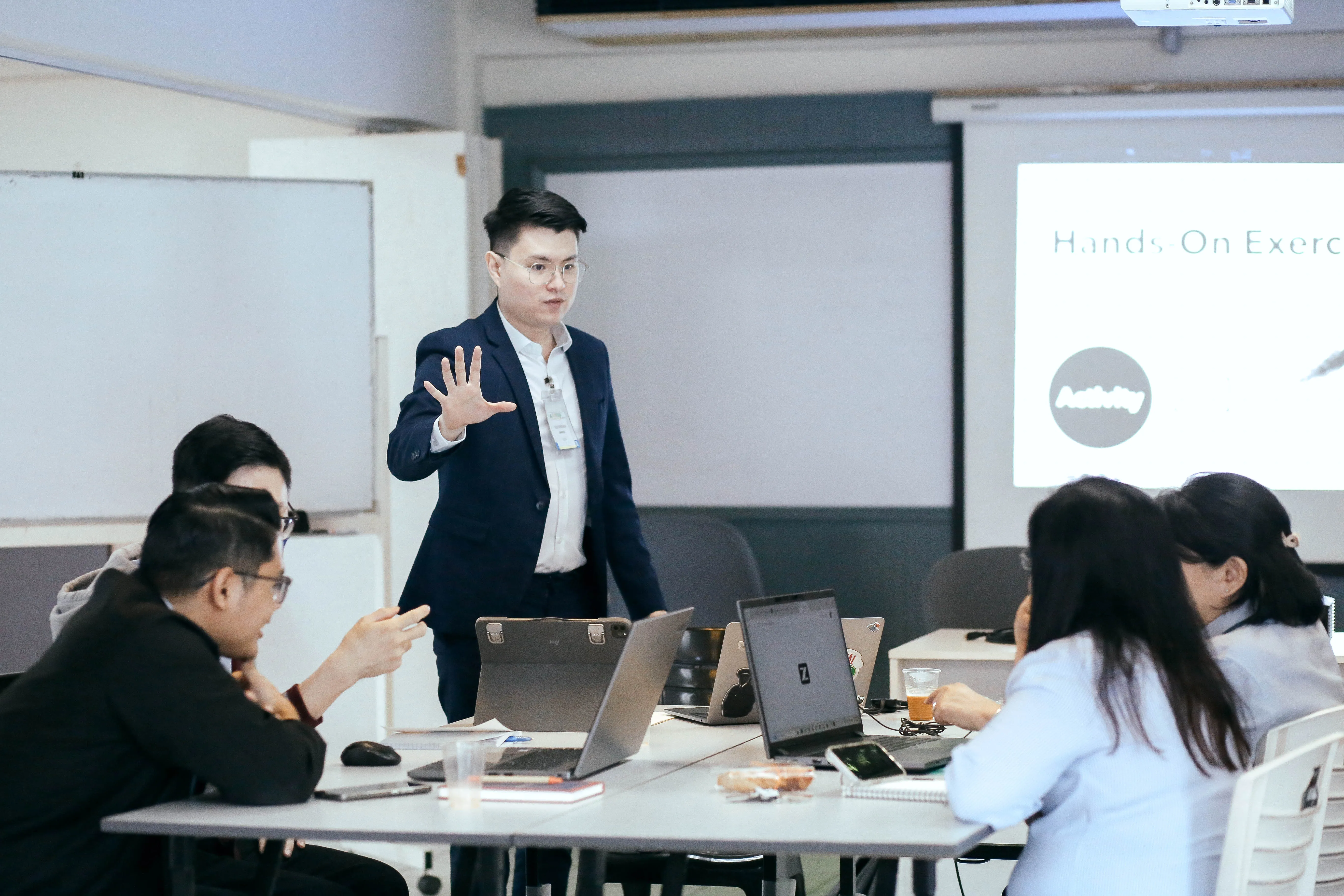 Participants in a hands-on AI training exercise led by a GrowthPro Asia facilitator.