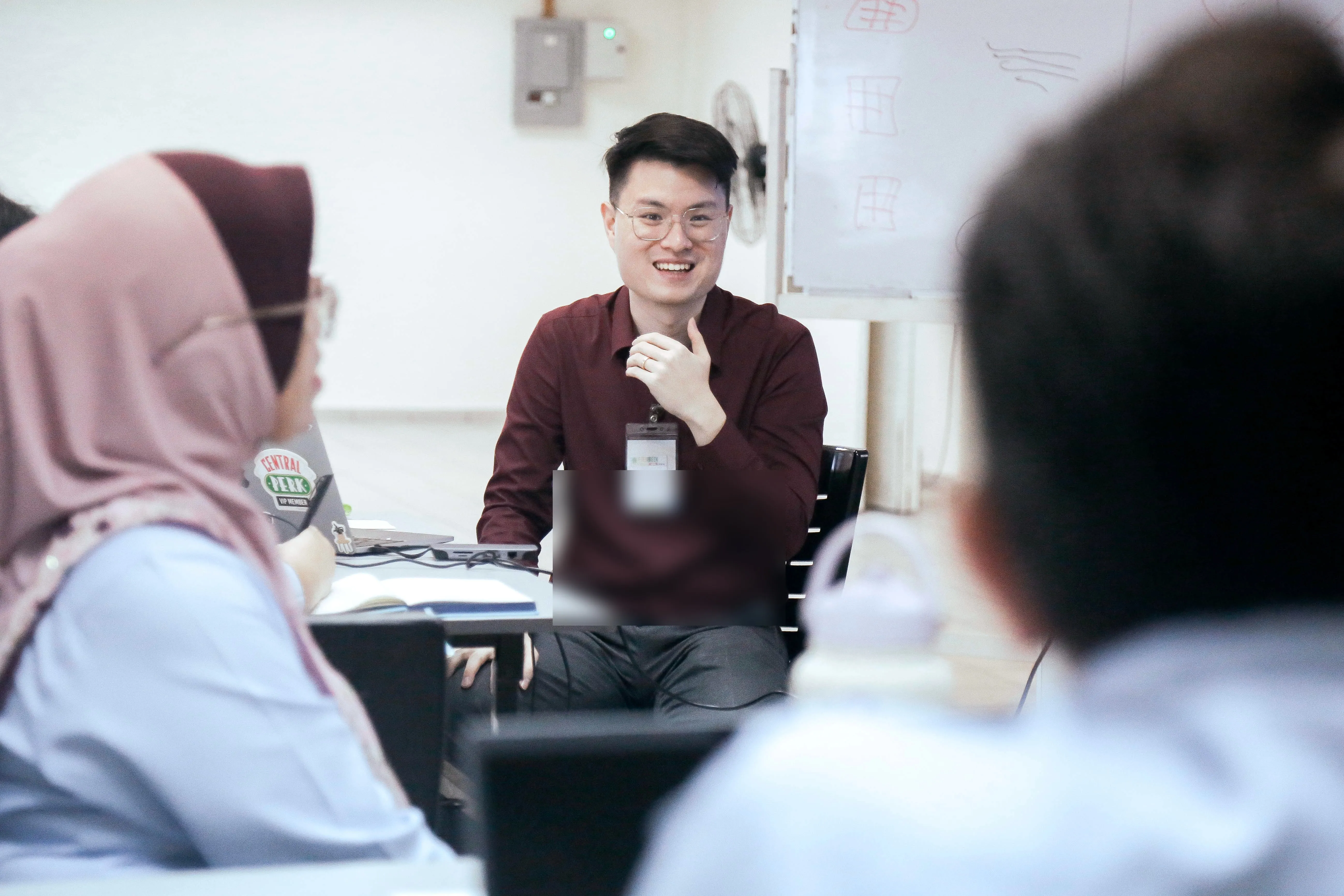 GrowthPro Asia trainer in conversation with participants during a session.